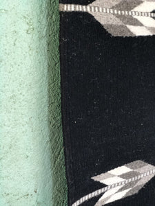 Handwoven Arroyo wool rug, arrow design with blacks, greys, white and cream.